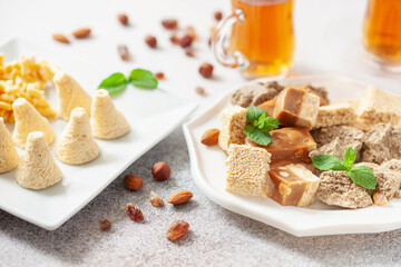 Oriental sweetness.  Nougat, halva and  tea on a table.