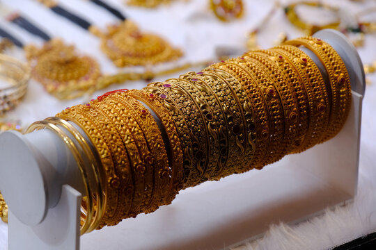 Indian Gold bangles displayed in local shop in a market of Pune, India, These bangles are made of Gold and diamond as beauty accessories by Indian women.