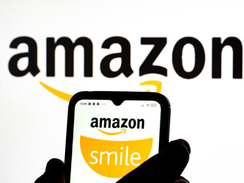 In this photo illustration Amazon Smile logo seen displayed on a smartphone