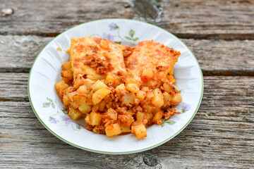  Potato and minced meat  Casserole  with   parmesan cheese and garlic on wooden rustic bakcground.  Bulgarian moussaka