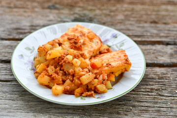  Potato and minced meat  Casserole  with   parmesan cheese and garlic on wooden rustic bakcground.  Bulgarian moussaka