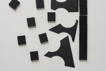 black tiles and paper shapes