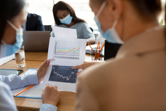 Business People Wearing Protective Face Masks Working With Documents In Office