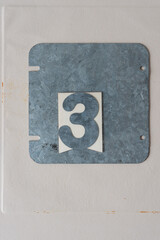 galvanized steel plate with the number three on paper