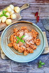  Home made italian   radiatori bolognese fresh   pasta  on rustic background. Mediterranean food concept