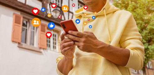 Portrait of male using smart phone in city sunset background.Man using app reading text message...