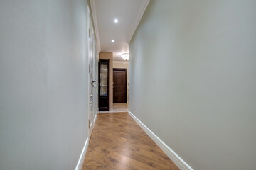 long empty corridor in interior of entrance hall of modern apartments, office or clinic