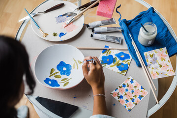 Woman painting plate in studio