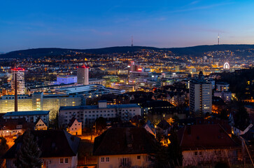 Stuttgart Cauldron colorful nighttime panorama. Illuminated town at winter holidays evening blue...