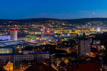 Fototapeta na wymiar Stuttgart Cauldron nighttime panorama. Illuminated town at winter evening blue hour with hundreds of lights. Capital and largest city of the German state of Baden-Württemberg. Cradle of automobile.