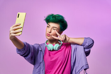 Cheerful millennial woman taking selfie