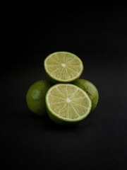 Lime isolated on black background, Whole and half of limes closeup, Citrus fruit 