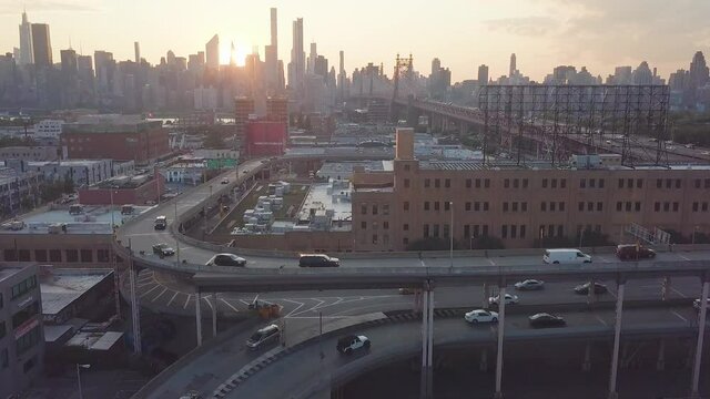 Aerial of cars traveling around Queensboro Plaza in Queens New York during golden hour