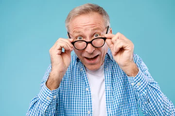 Fotobehang Surprised mature man in glasses staring at camera © Prostock-studio