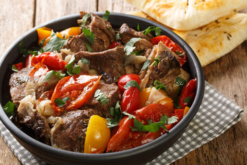 Buglama traditional lamb and vegetables recipe from Azerbaijan, Turkey and the surrounding area closeup in the Bowl on the wooden table. Horizontal