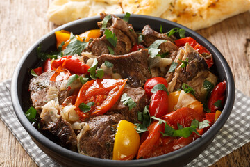 Buglama Traditional hot ragout with meat and vegetables closeup in the Bowl on the wooden table. Horizontal
