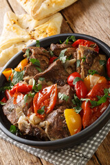Beautiful Homemade Buglama or Lamb with Vegetables and Fragrant Herbs closeup in the Bowl. Rustic Background