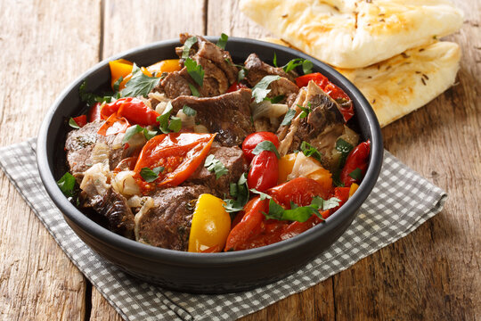 Lamb Buglama is a popular Azerbaijani and Georgian dish closeup in the bowl on the wooden table. Horizontal