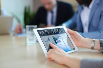 People meeting analyzing financial statistics in office. Group of business team having video conference with their team on digital tablet, remote work at home.