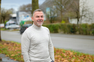 Middle-aged man posing in an urban street in winter