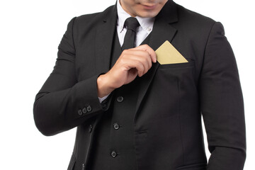 Close up handsome business man in black suit put or take out credit card in pocket isolated on...