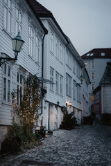 Moody winter time -  white houses on a old town street in Bergen, Norway.