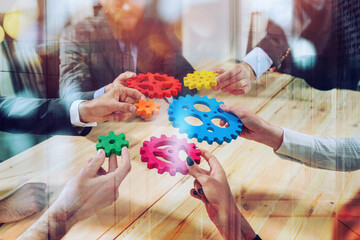 Business team connect pieces of gears like a teamwork and partners