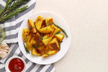 Fried potatoes with garlic and rosemary in a white plate. Top view. Copy space.