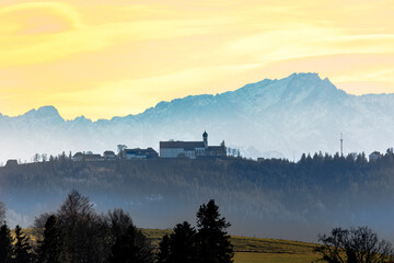 Pilgrimage church on the Hohe Peissenberg with the mountain panorama of the Ammergaues Alps in the background