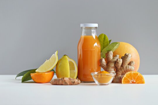 Ginger shot with citrus fruits juice, turmeric and honey. Pure vegan Immunity system booster. Copy space