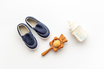 Baby newborn accessories with blue booties bootle of milk and toy