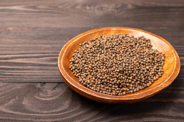 coriander seeds in a wooden bowl
