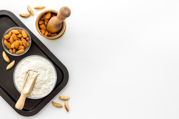 Pestle almond flour - nuts with mortar on kitchen table