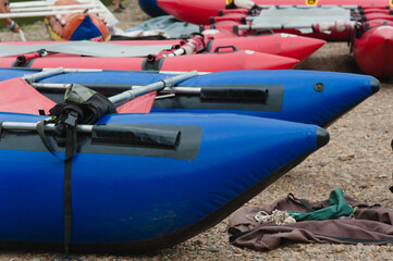 There are many inflatable boats at the pier ready for rafting down the mountain river.
