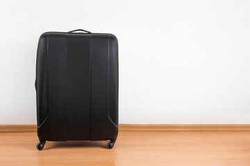 Black travel bag suitcase luggage at home white wall background