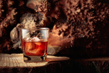 Whiskey with ice on an old dried stump.