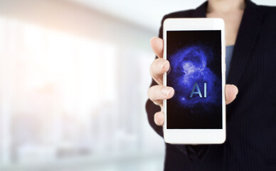The modern concept of the cyberbrain. Hand hold white smartphone with digital hologram Artificial intelligence sign on light blurred background. Virtual Reality or Artificial Intelligence technology