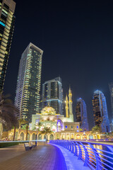 Mosque at Dubai Marina skyline architecture wealth luxury travel at night portrait format in United...