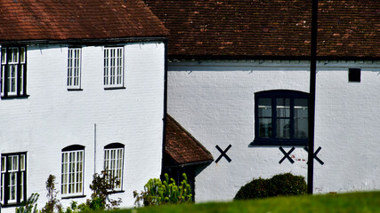 Traditional old brick houses painted white in the village, Kenilworth, England, UK