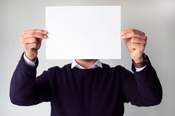 man holding blank white paper