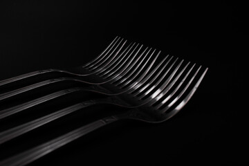 Plugs with metal, silver, lie on a black background