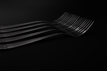 Plugs with metal, silver, lie on a black background