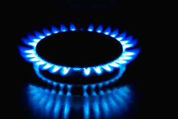Flame of a gas burner on a black background. Combustion of Natural gas on a black background. Gas stove. Gas stove burner on fire. Fossil fuel. Hydrocarbons. Gas crisis in Europe.