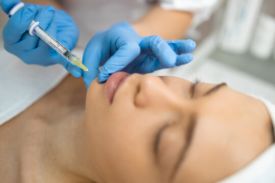 Close up of female face during the injection in the chin