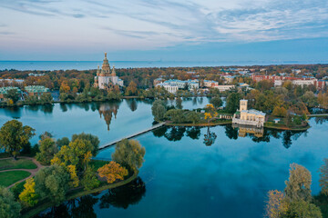 Fototapeta na wymiar Panoramic aerial view of Holgin pond and the islands with pavilions in Peterhof,Peter and Paul Cathedral, wooden bridge to the island, reflected in the water, photo for a postcard