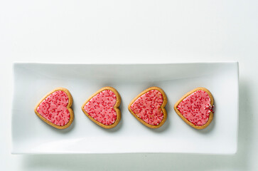 Top view of some strawberries cookies on a white background with copy space. 