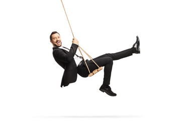 Full length side shot of a happy businessman swinging on a swing - obrazy, fototapety, plakaty