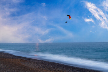 Seascape by the sea on the island of Crete - Greece hotel Almyra. Parasol and sunbeds, there are dramatic clouds in the sky.