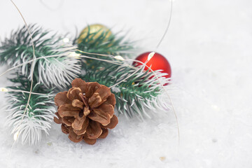 Obraz na płótnie Canvas Christmas composition of Christmas tree toy red and gold ball snow background tree branch cone