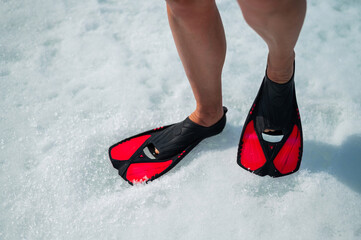 Woman in flippers in the snow. Close-up of the female feet. © Михаил Решетников
